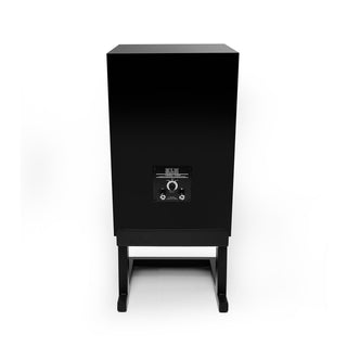 A black rectangular speaker cabinet on a matching black stand, photographed from the rear against a plain white background.