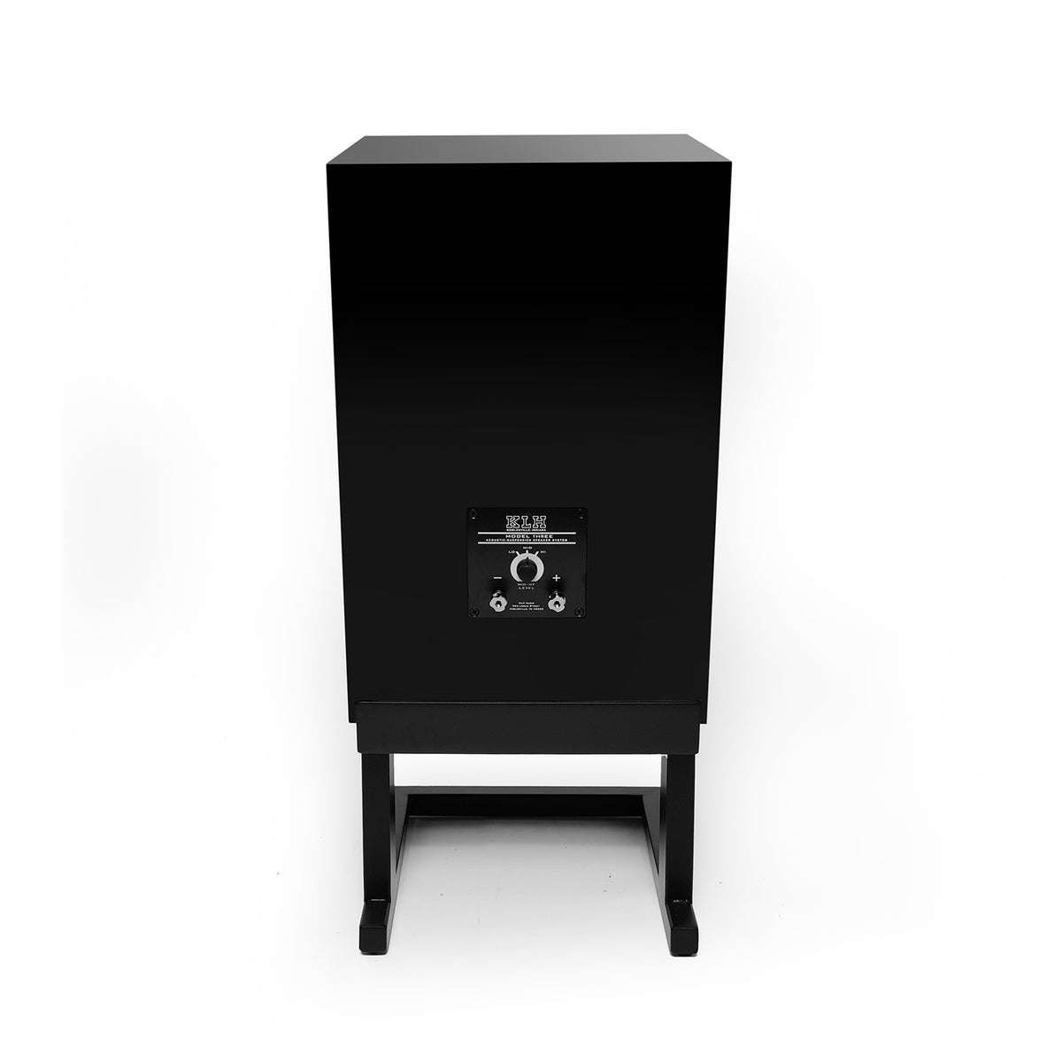 A black rectangular speaker cabinet on a matching black stand, photographed from the rear against a plain white background.
