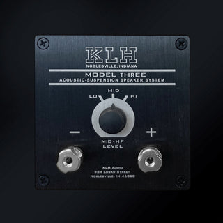 KLH Model Three acoustic suspension speaker system control panel, featuring a brushed black metal faceplate with white text and a central rotary switch, photographed against a dark background.