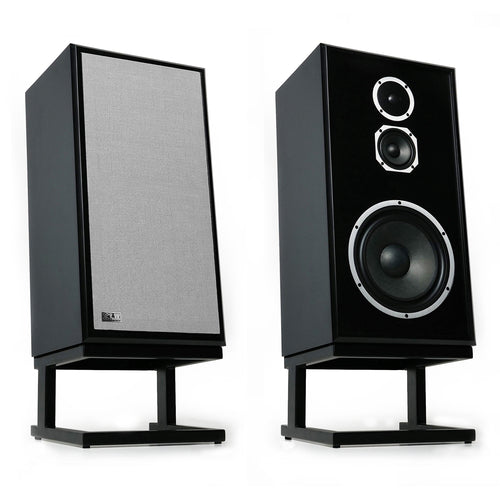 Two black bookshelf speakers on stands, one showing the front grille and the other showing the front face with two drivers, on a white background.