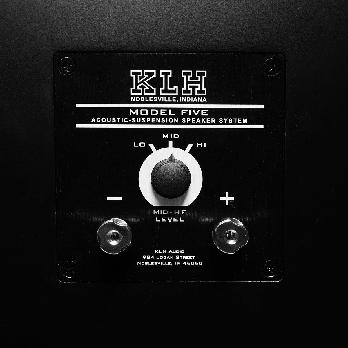 Close-up of a black speaker system control panel with white text reading 'KHH Koblesville, Indiana Model Five Acoustic-Suspension Speaker System' and a central rotary knob labeled LO, MID, HI, and MID-HF LEVEL.